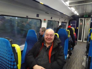 Dennis Fancett sitting aboard a Northumberland Line train